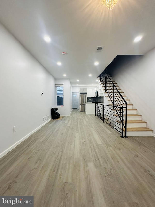 unfurnished living room with light wood-type flooring