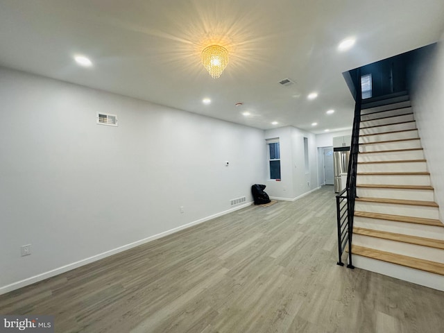 basement with hardwood / wood-style floors