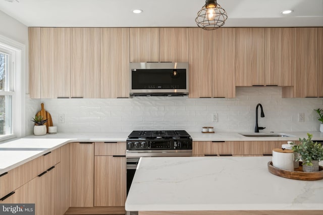 kitchen with backsplash, sink, and light brown cabinets