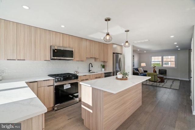 kitchen with decorative light fixtures, stainless steel appliances, a kitchen island, and dark hardwood / wood-style floors