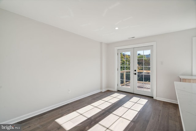 unfurnished room featuring french doors and hardwood / wood-style flooring