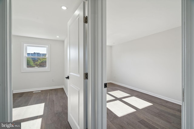 hall with dark wood-type flooring