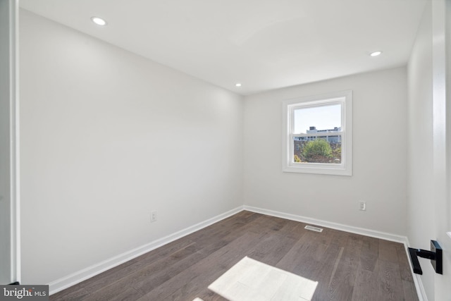 spare room featuring dark hardwood / wood-style flooring