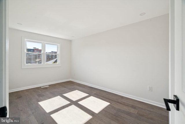 empty room with dark hardwood / wood-style floors