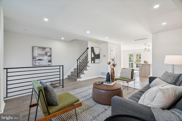 living room featuring wood-type flooring and french doors