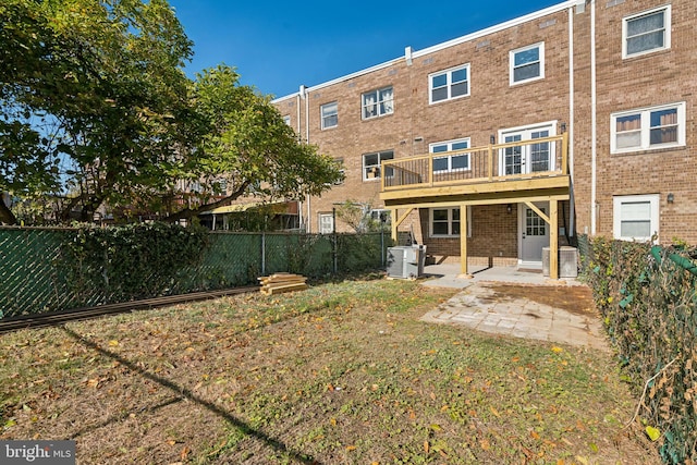 rear view of house featuring a patio and a lawn