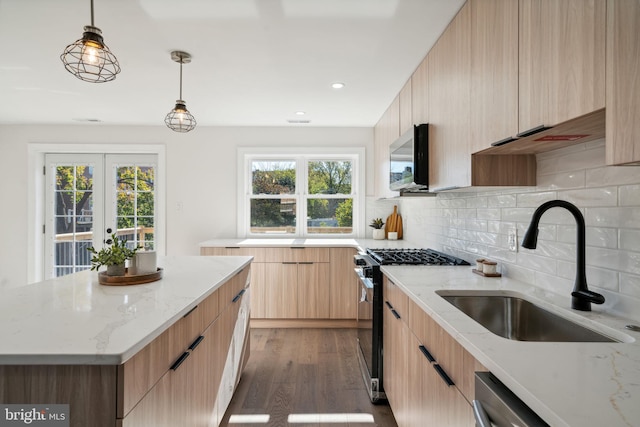 kitchen with hardwood / wood-style flooring, a center island, a healthy amount of sunlight, and appliances with stainless steel finishes