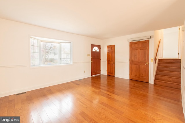 spare room with hardwood / wood-style floors