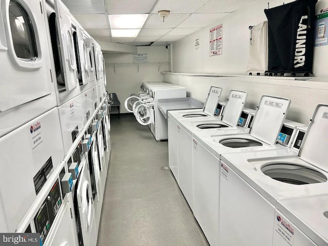 washroom with stacked washing maching and dryer and washing machine and clothes dryer