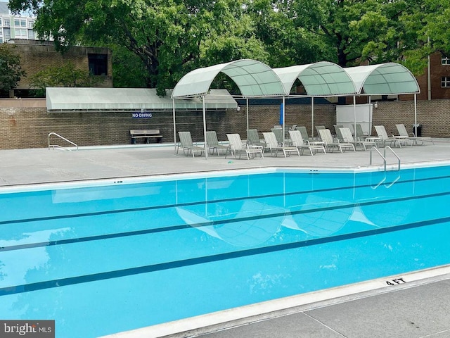 view of swimming pool with a patio area