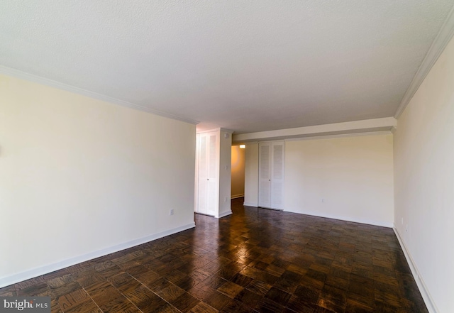 unfurnished room with a textured ceiling and ornamental molding