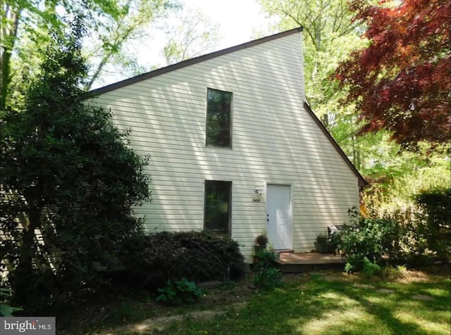 rear view of property with a yard