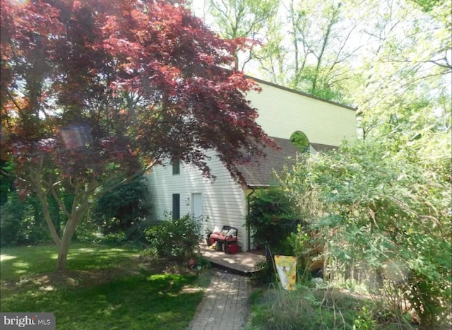 view of property exterior featuring a lawn