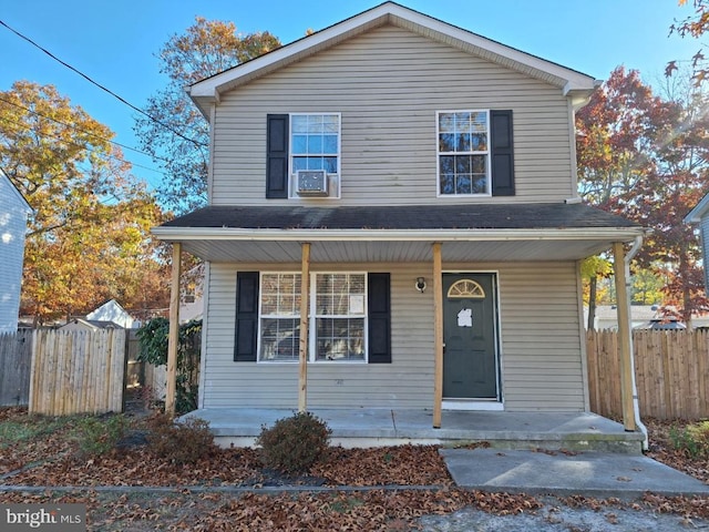 view of front property featuring a porch and cooling unit