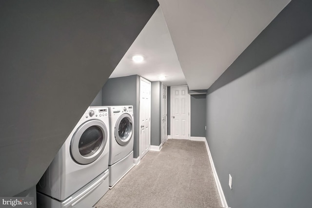 laundry room featuring light carpet and independent washer and dryer