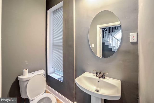 bathroom featuring sink, plenty of natural light, and toilet