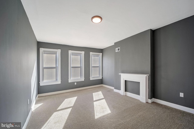 unfurnished living room with light carpet