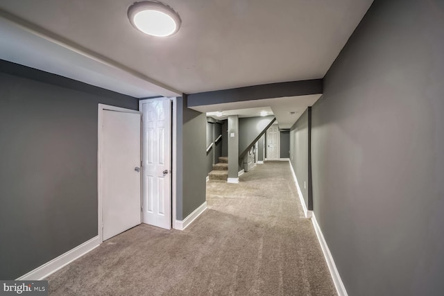 corridor featuring light colored carpet