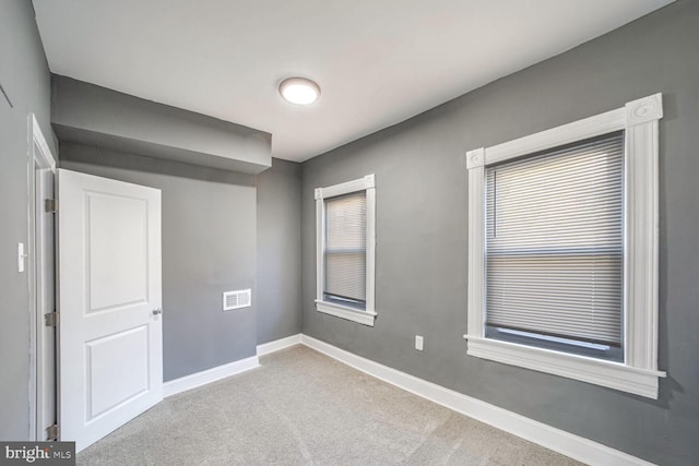 spare room featuring light colored carpet