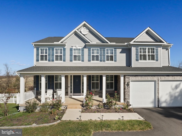 view of front of home featuring covered porch and a garage