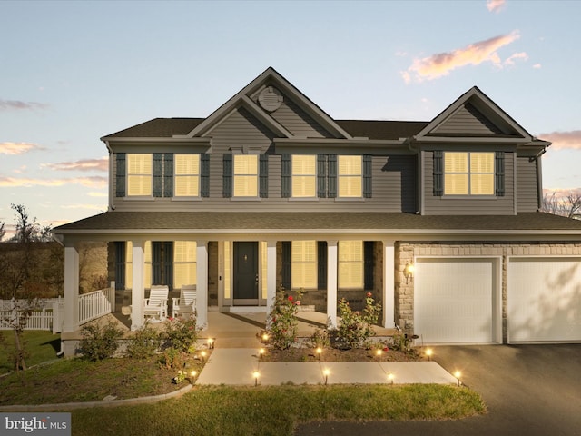 view of front of property featuring a porch and a garage