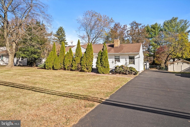 cape cod home with a front yard