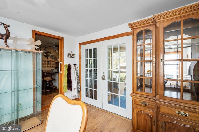 doorway with light hardwood / wood-style floors and french doors