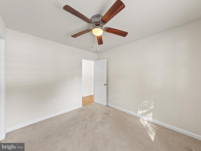 carpeted spare room with ceiling fan