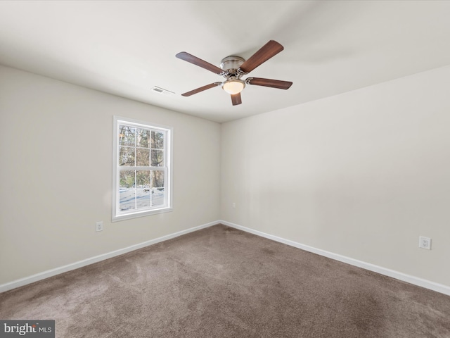 carpeted spare room featuring ceiling fan