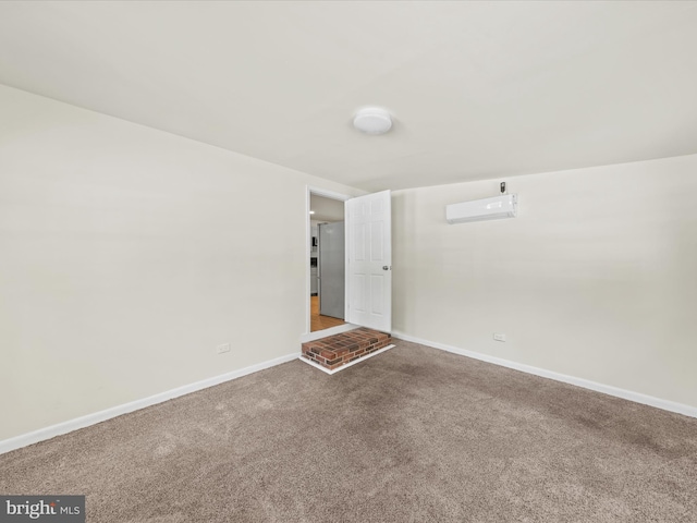 carpeted spare room featuring an AC wall unit