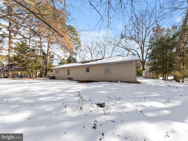 view of snow covered back of property