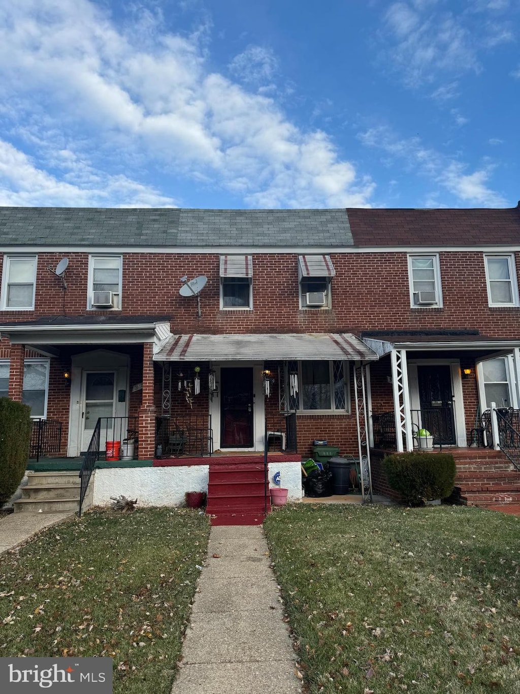 multi unit property with cooling unit, covered porch, and a front yard