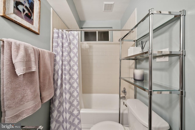 bathroom featuring toilet and shower / tub combo