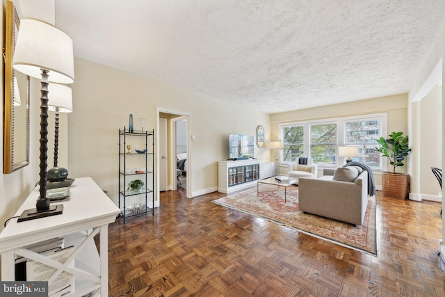 living room with dark parquet flooring and a textured ceiling