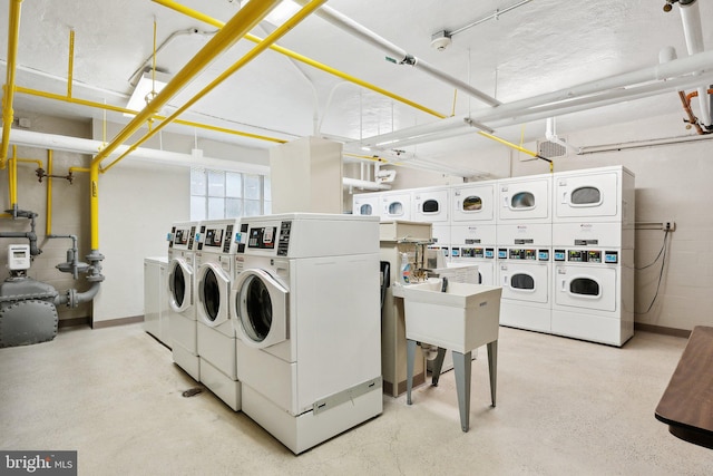 washroom with washing machine and dryer and stacked washer / drying machine