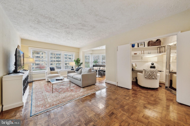 living room with dark parquet floors and a textured ceiling