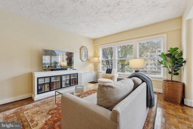 living room with a textured ceiling and parquet flooring