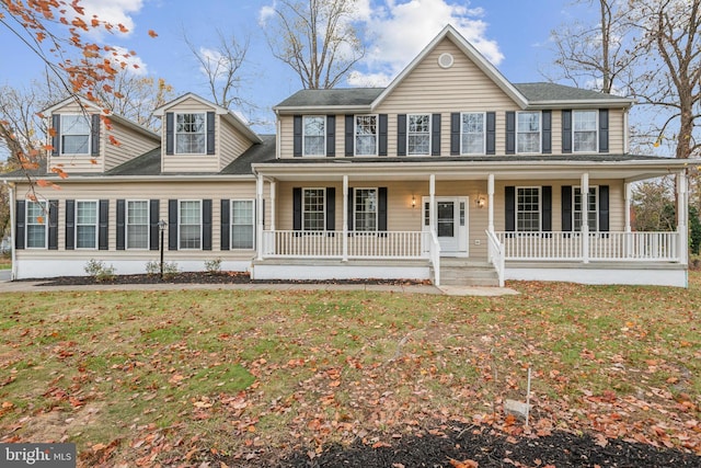 view of front of home with a porch and a front yard