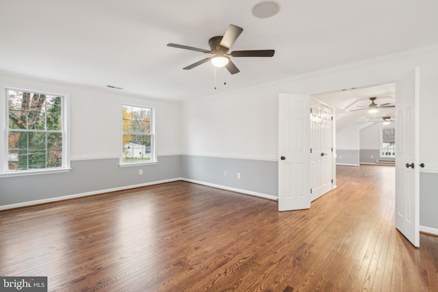 spare room featuring hardwood / wood-style floors, ceiling fan, and ornamental molding