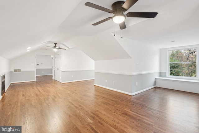 bonus room with ceiling fan, hardwood / wood-style floors, and lofted ceiling