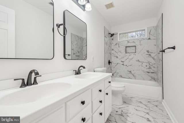 full bathroom featuring toilet, vanity, and tiled shower / bath