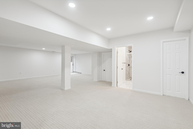 basement featuring light carpet