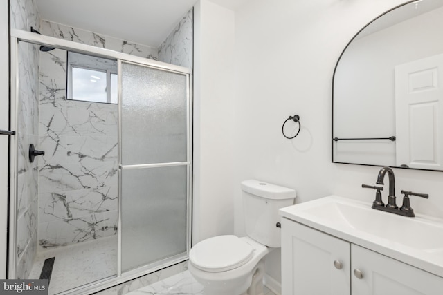 bathroom featuring vanity, toilet, and walk in shower