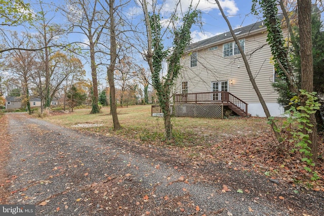 view of side of home featuring a wooden deck