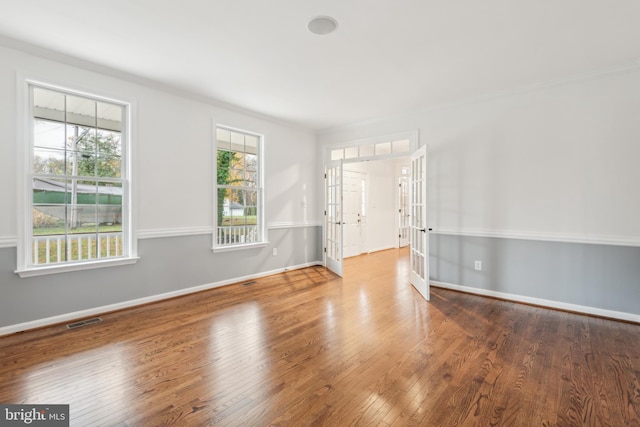 spare room with wood-type flooring and french doors