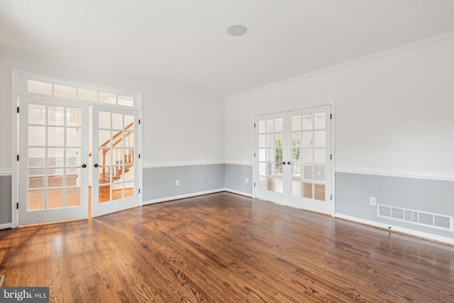 spare room with french doors, hardwood / wood-style flooring, and crown molding