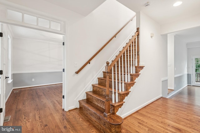 stairs with hardwood / wood-style flooring