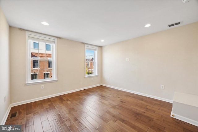 spare room with dark wood-type flooring