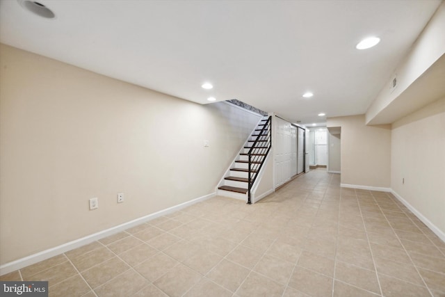 basement featuring light tile patterned flooring