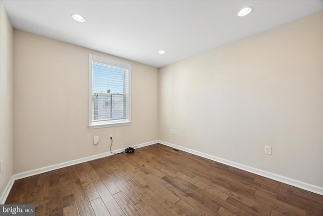 unfurnished room with wood-type flooring